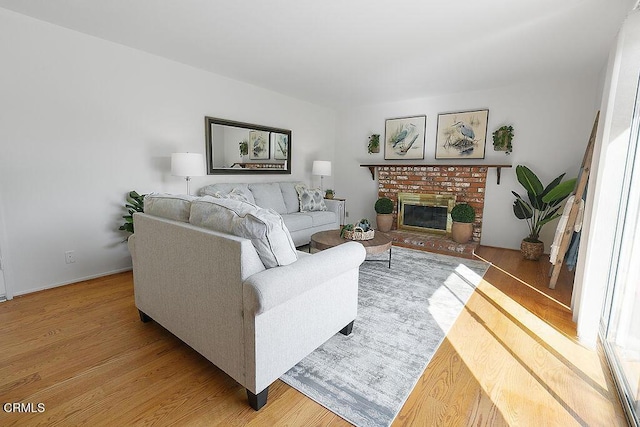 living room featuring wood-type flooring and a fireplace