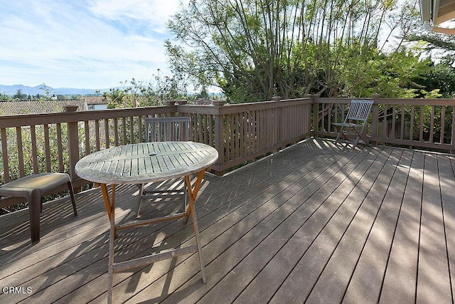 wooden deck with a mountain view