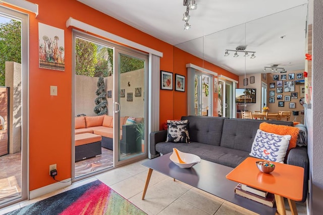 living room with rail lighting and light tile patterned floors