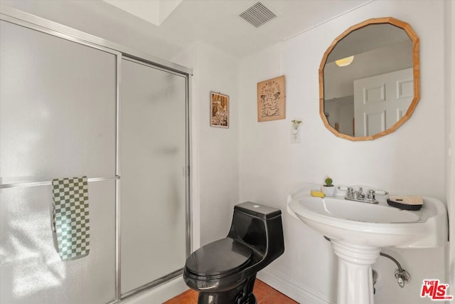 bathroom featuring walk in shower, toilet, and tile patterned flooring