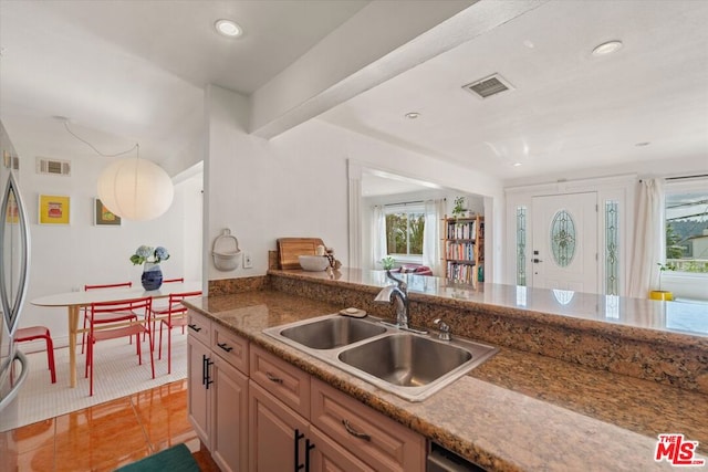 kitchen featuring sink and light tile patterned floors