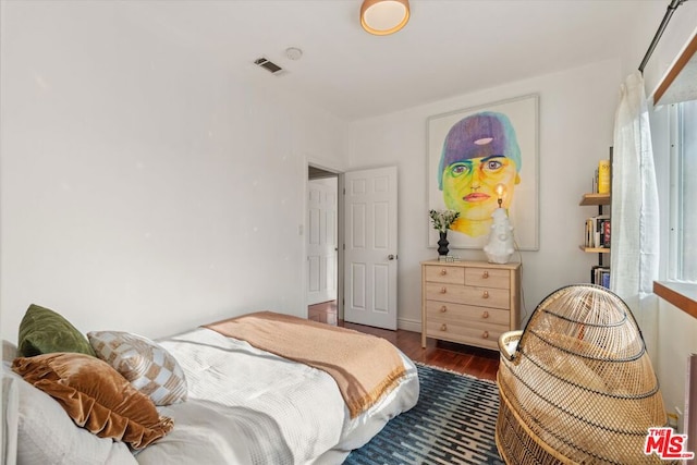 bedroom with dark hardwood / wood-style floors