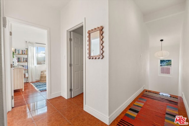 corridor with light tile patterned floors