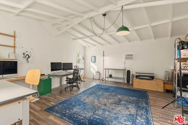 office space with wood-type flooring, an AC wall unit, and vaulted ceiling with beams