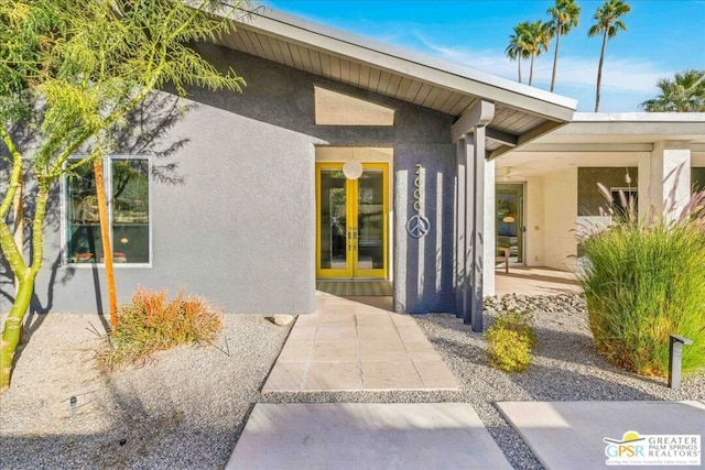 view of exterior entry featuring a patio area