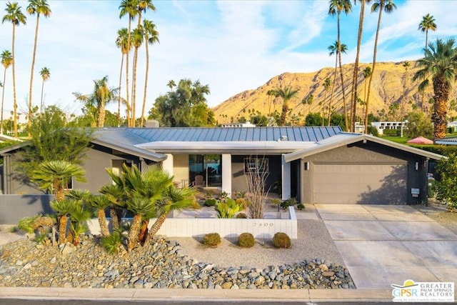 single story home featuring a garage and a mountain view