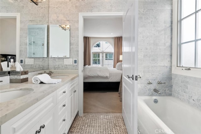 bathroom with vanity and a tub