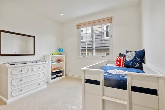 bedroom featuring light colored carpet