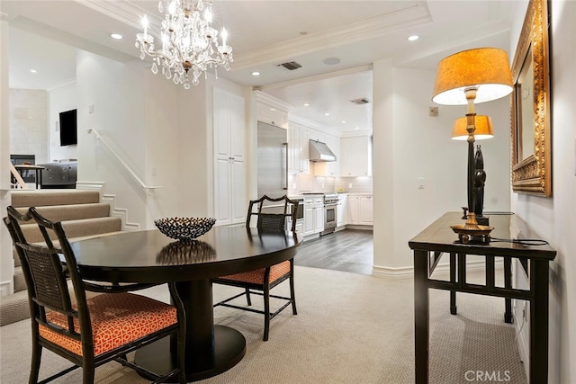 carpeted dining room featuring crown molding