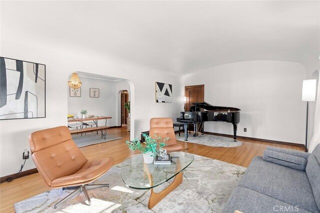 living room with wood-type flooring and vaulted ceiling