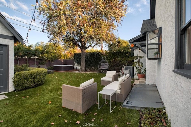 view of yard with an outdoor living space, a hot tub, and a patio area