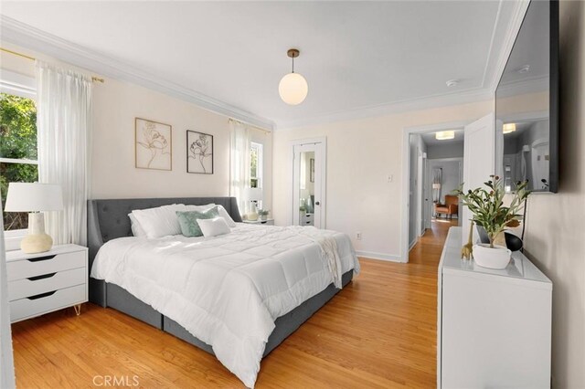 bedroom featuring crown molding, multiple windows, and light wood-type flooring