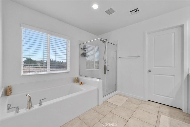 full bathroom featuring a stall shower, tile patterned flooring, visible vents, and a bath