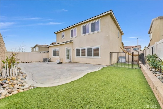 back of property featuring a patio area, a lawn, a fenced backyard, and stucco siding