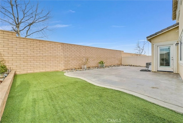 view of yard featuring a fenced backyard, cooling unit, and a patio