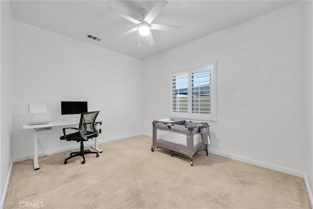 home office featuring light colored carpet and ceiling fan