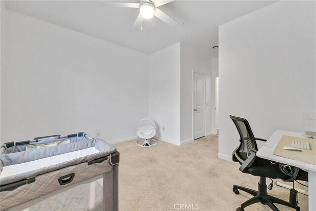 office space with light colored carpet and ceiling fan