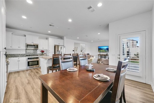 dining area with light hardwood / wood-style flooring