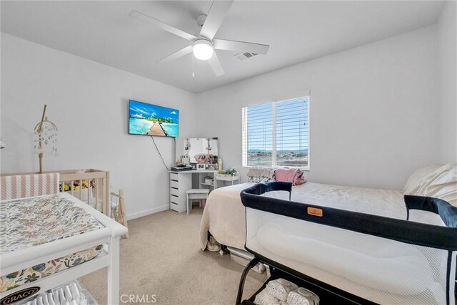 bedroom featuring ceiling fan and light colored carpet