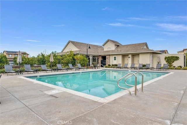 pool featuring a patio area and fence