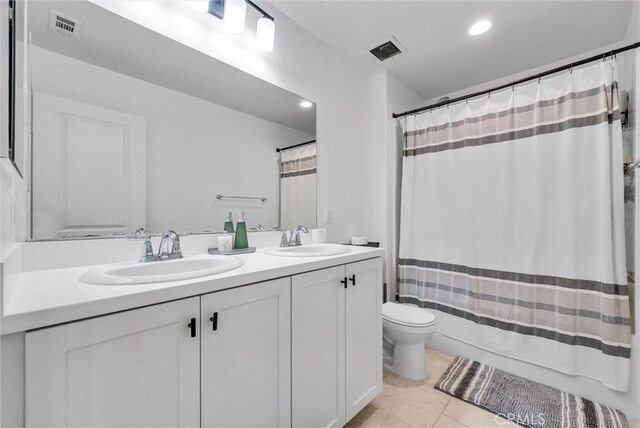 bathroom with vanity, tile patterned floors, and toilet