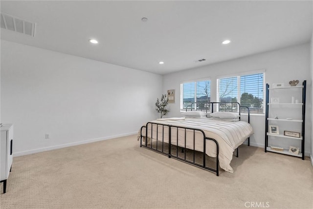 bedroom featuring baseboards, recessed lighting, visible vents, and light colored carpet