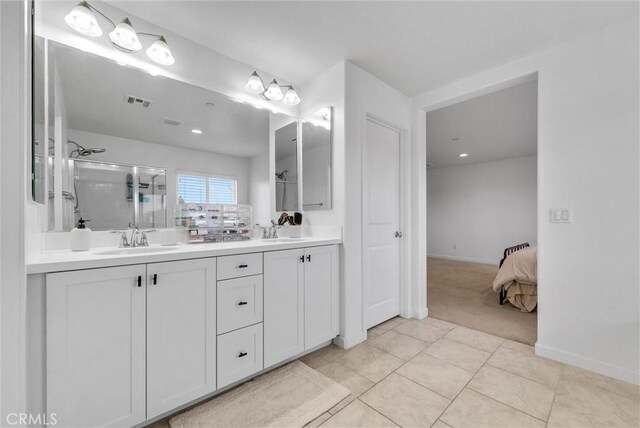 bathroom featuring tile patterned floors, vanity, and a shower with door