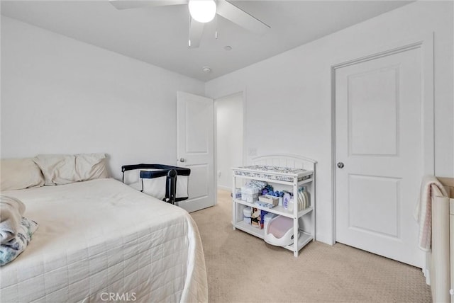 bedroom featuring light carpet and ceiling fan