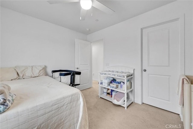 bedroom featuring a ceiling fan and light colored carpet