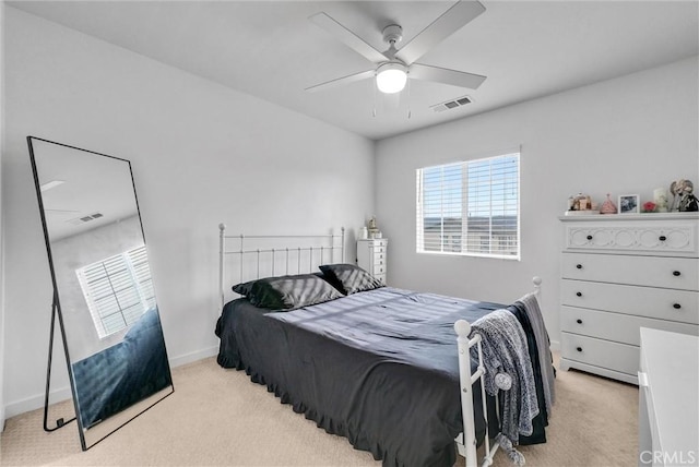 bedroom with baseboards, a ceiling fan, visible vents, and light colored carpet