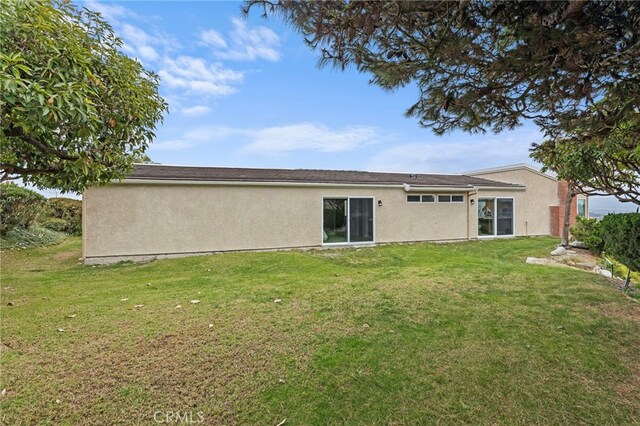 31002 Flying Cloud Dr, Laguna Niguel, CA 92677 - rear view of property featuring stucco siding and a lawn