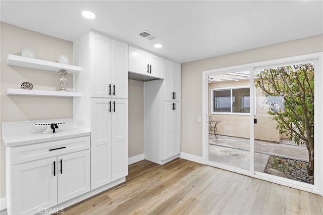 31002 Flying Cloud Dr, Laguna Niguel, CA 92677 - kitchen featuring light wood-style floors, open shelves, light countertops, white cabinetry, and recessed lighting