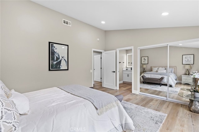 bedroom with hardwood / wood-style floors and vaulted ceiling