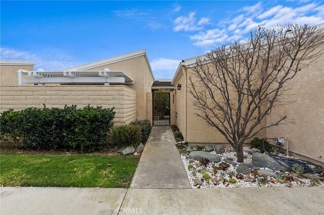 31002 Flying Cloud Dr, Laguna Niguel, CA 92677 - view of property exterior with stucco siding and a gate