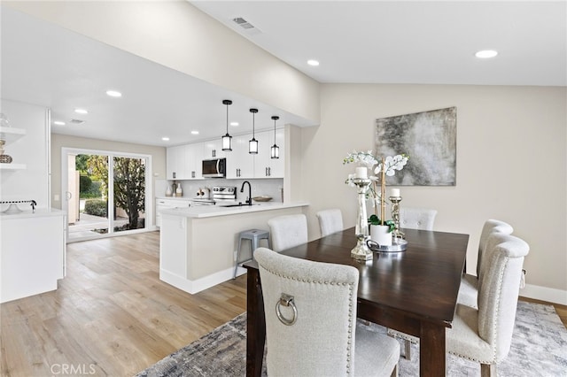 dining area featuring sink and light hardwood / wood-style floors