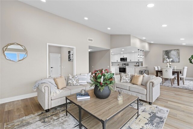31002 Flying Cloud Dr, Laguna Niguel, CA 92677 - living area featuring light wood finished floors, recessed lighting, and lofted ceiling