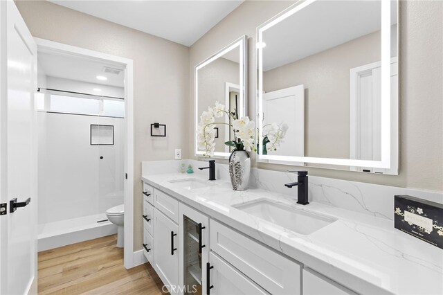 31002 Flying Cloud Dr, Laguna Niguel, CA 92677 - bathroom with double vanity, a shower stall, wood finished floors, and recessed lighting