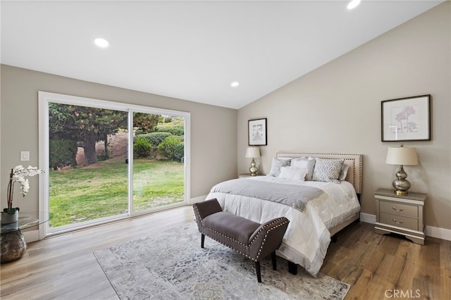 bedroom with access to exterior, vaulted ceiling, and wood-type flooring