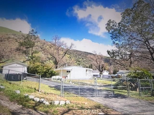 view of road featuring a gate, driveway, and a gated entry