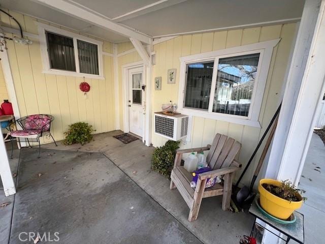 doorway to property with a patio and cooling unit