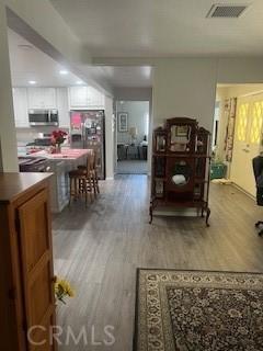 interior space with visible vents and wood finished floors