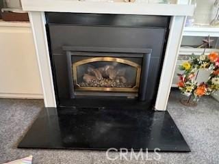 interior details with a glass covered fireplace