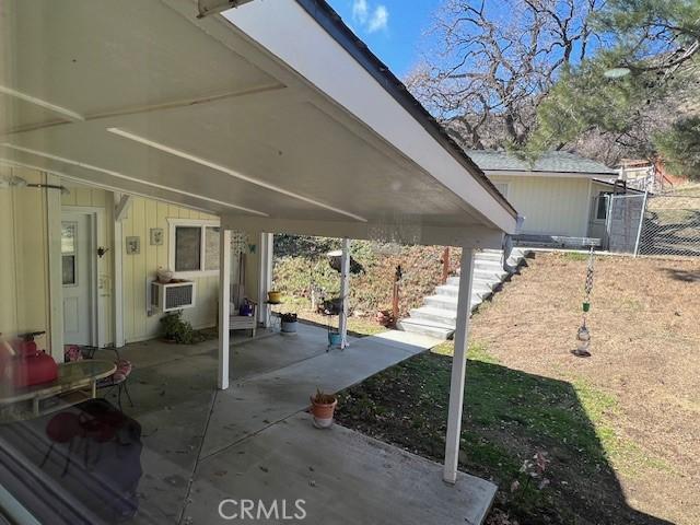 view of patio with fence and cooling unit