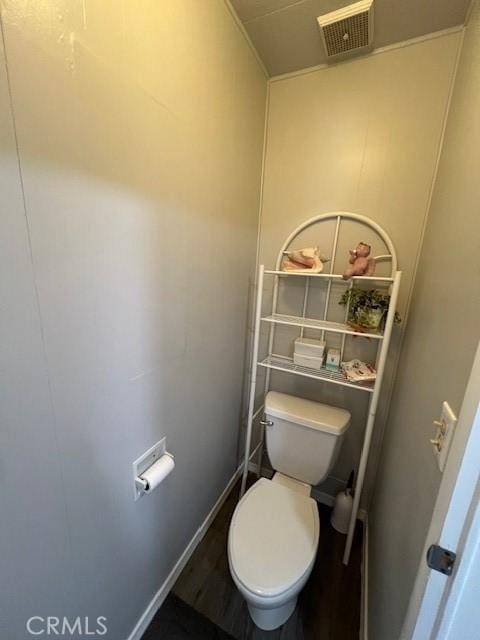 bathroom with toilet, baseboards, and visible vents