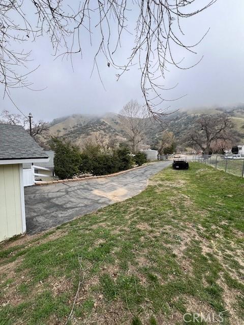 view of yard with fence and a mountain view