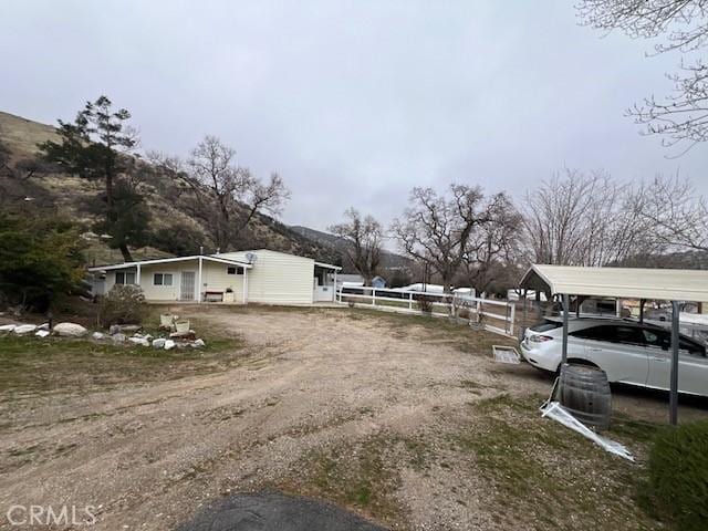 exterior space featuring a carport and fence