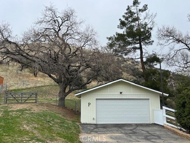 detached garage featuring fence