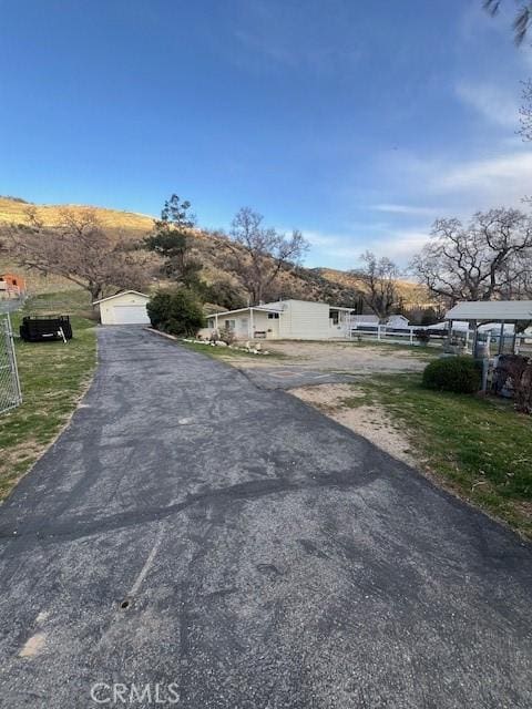 view of street with driveway and a gated entry