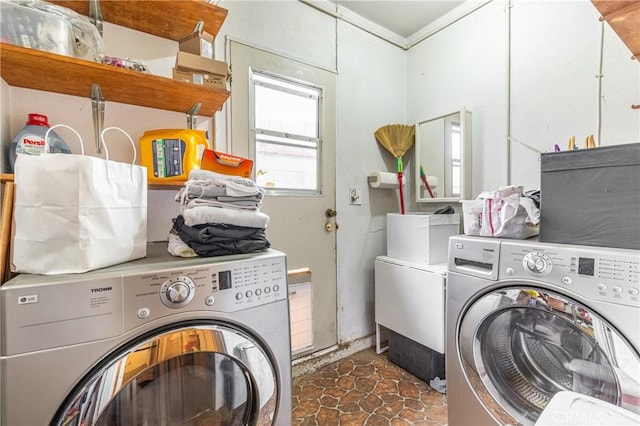 clothes washing area featuring crown molding and separate washer and dryer