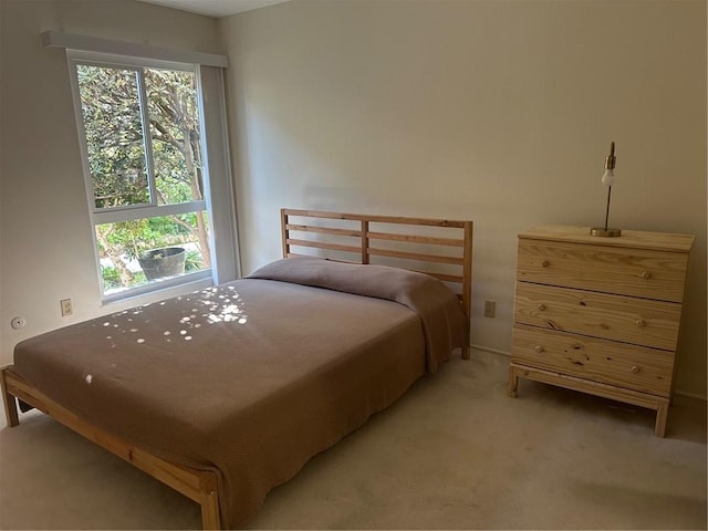 bedroom featuring light colored carpet